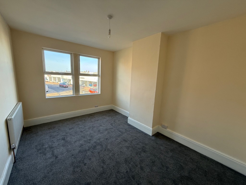 Lot: 63 - COMMERCIAL INVESTMENT WITH VACANT FLAT ABOVE - Bedroom one with two windows to the front